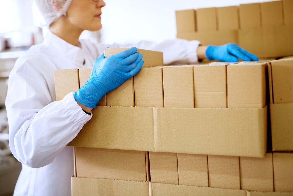 A warehouse working unpacking a pallet of boxes